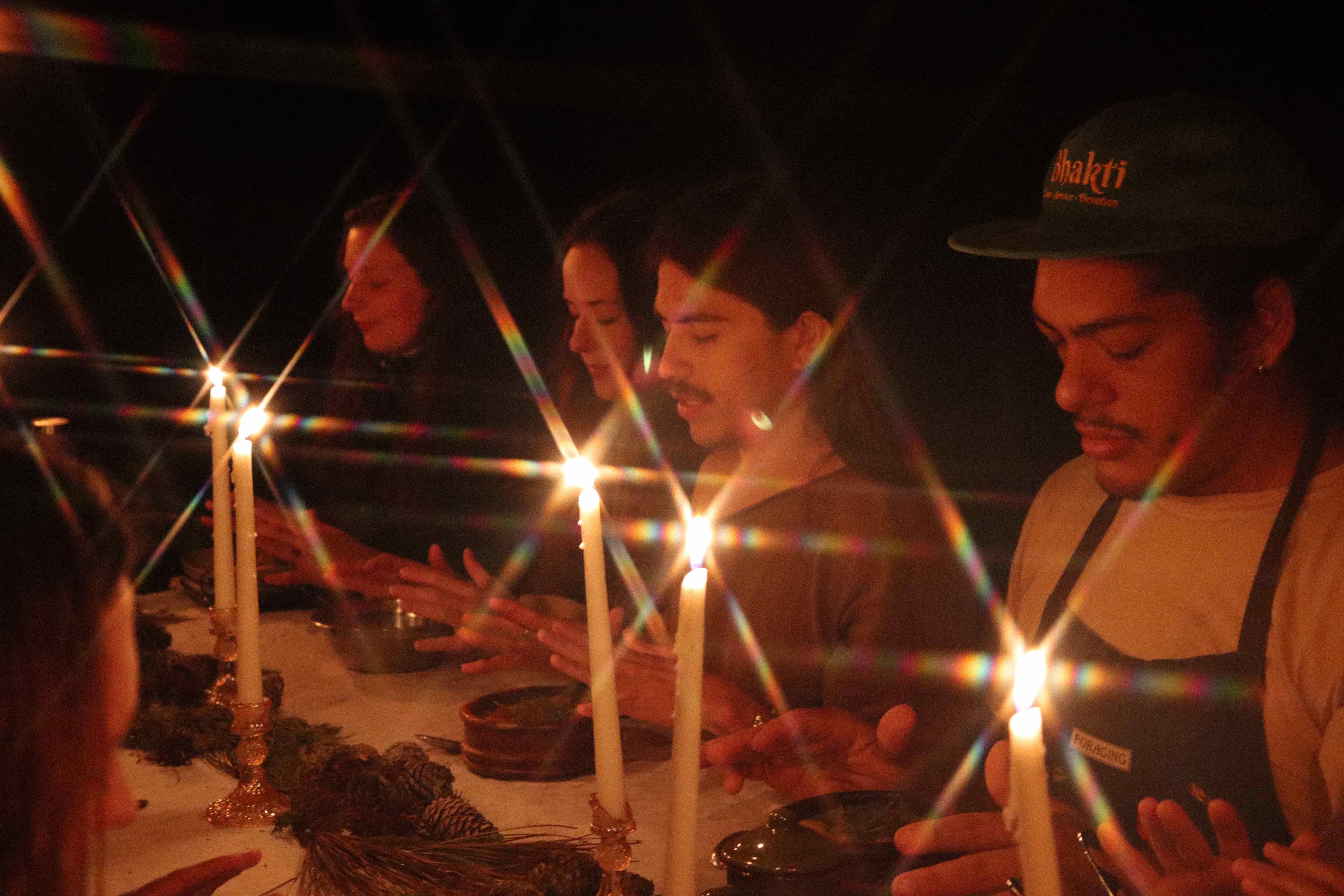 Sacred candlelit ceremony with women in spiritual gathering