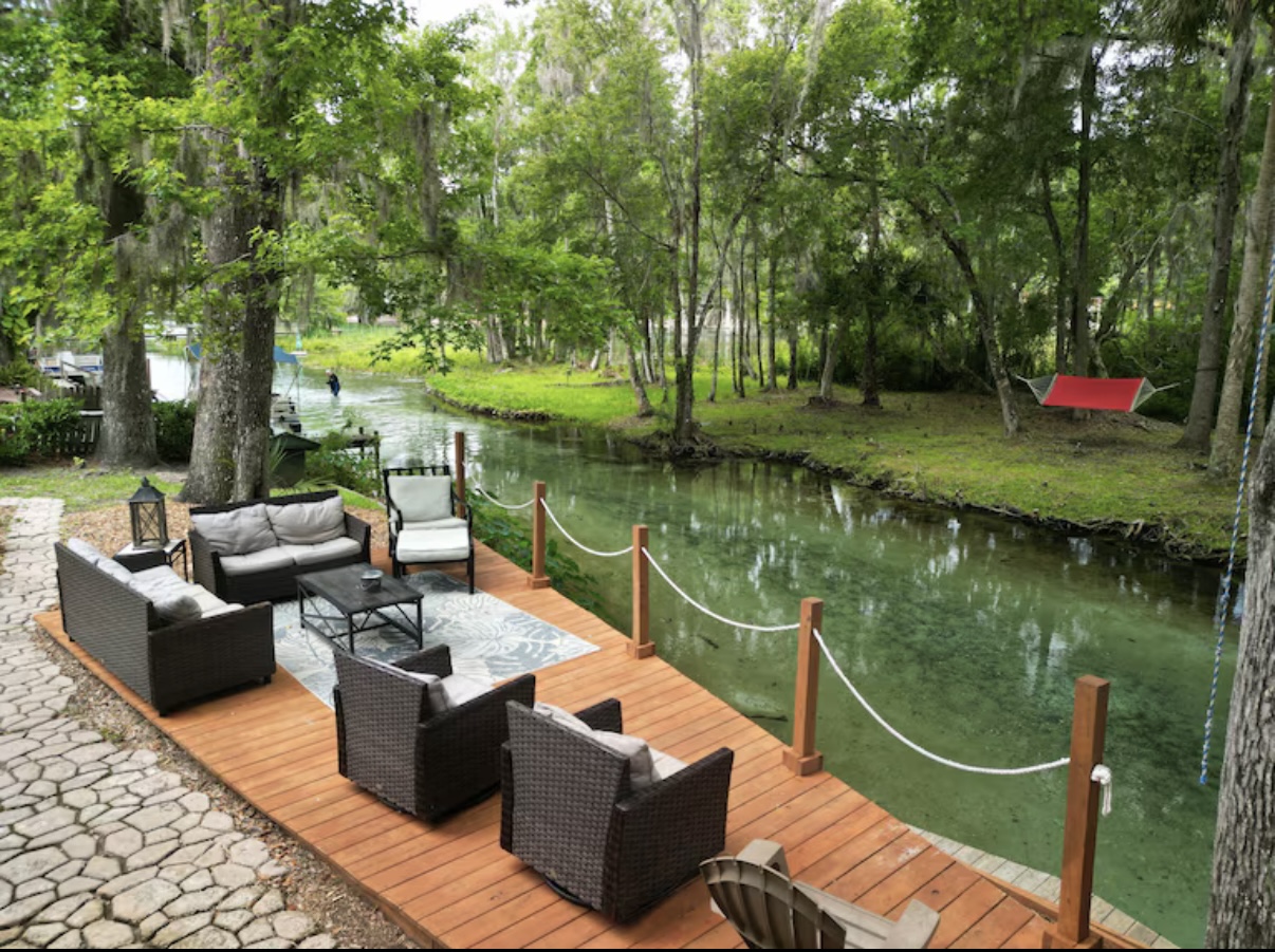 Outdoor deck seating area overlooking spring water