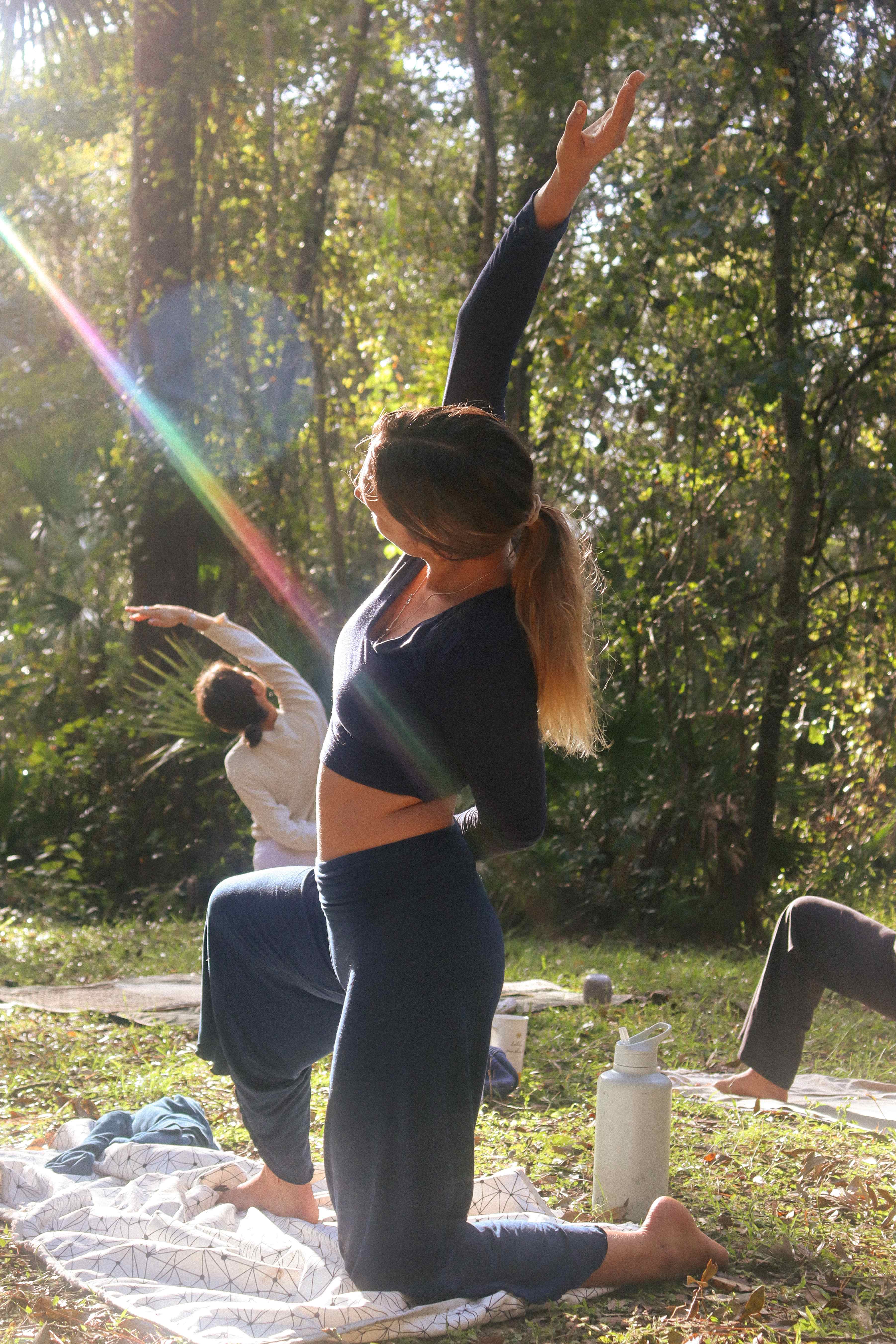 Dynamic yoga poses with arms raised in lunge