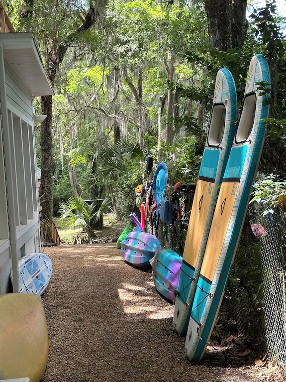 Water sports equipment storage with paddleboards and kayaks