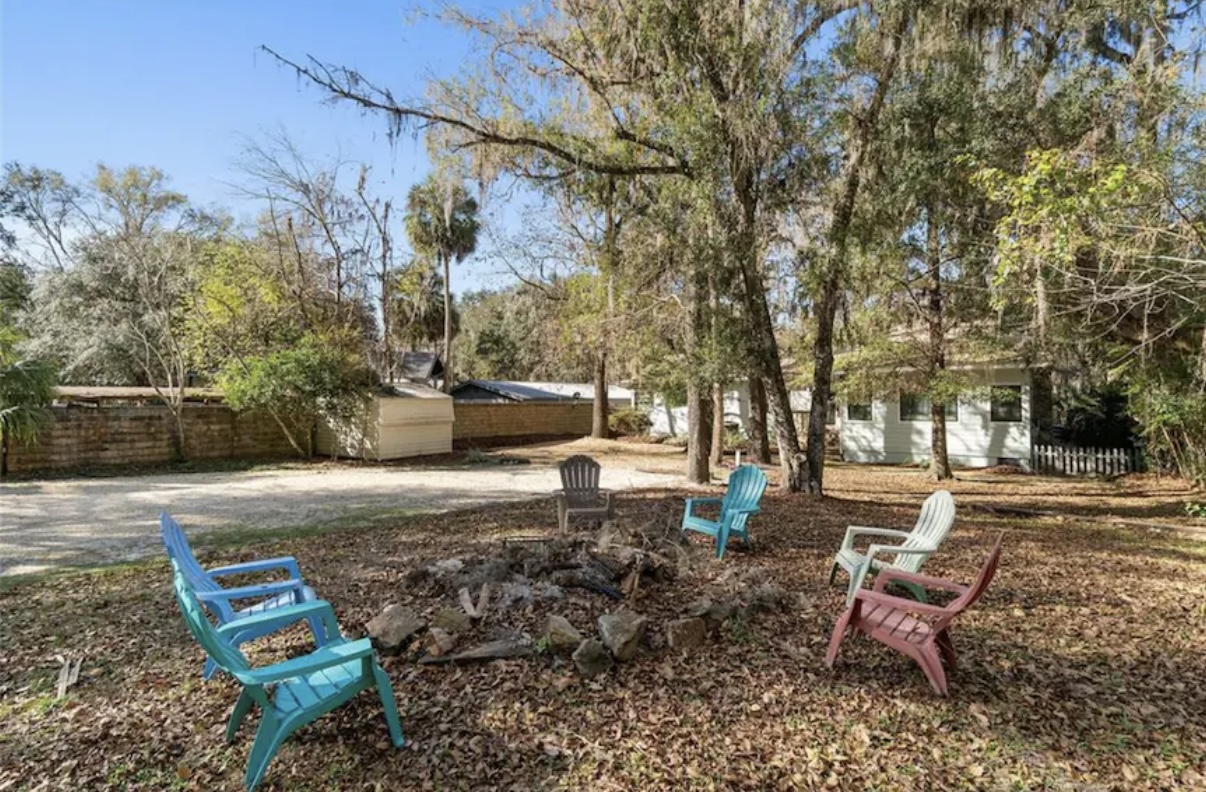 Fire pit area with colorful chairs for evening bonfires