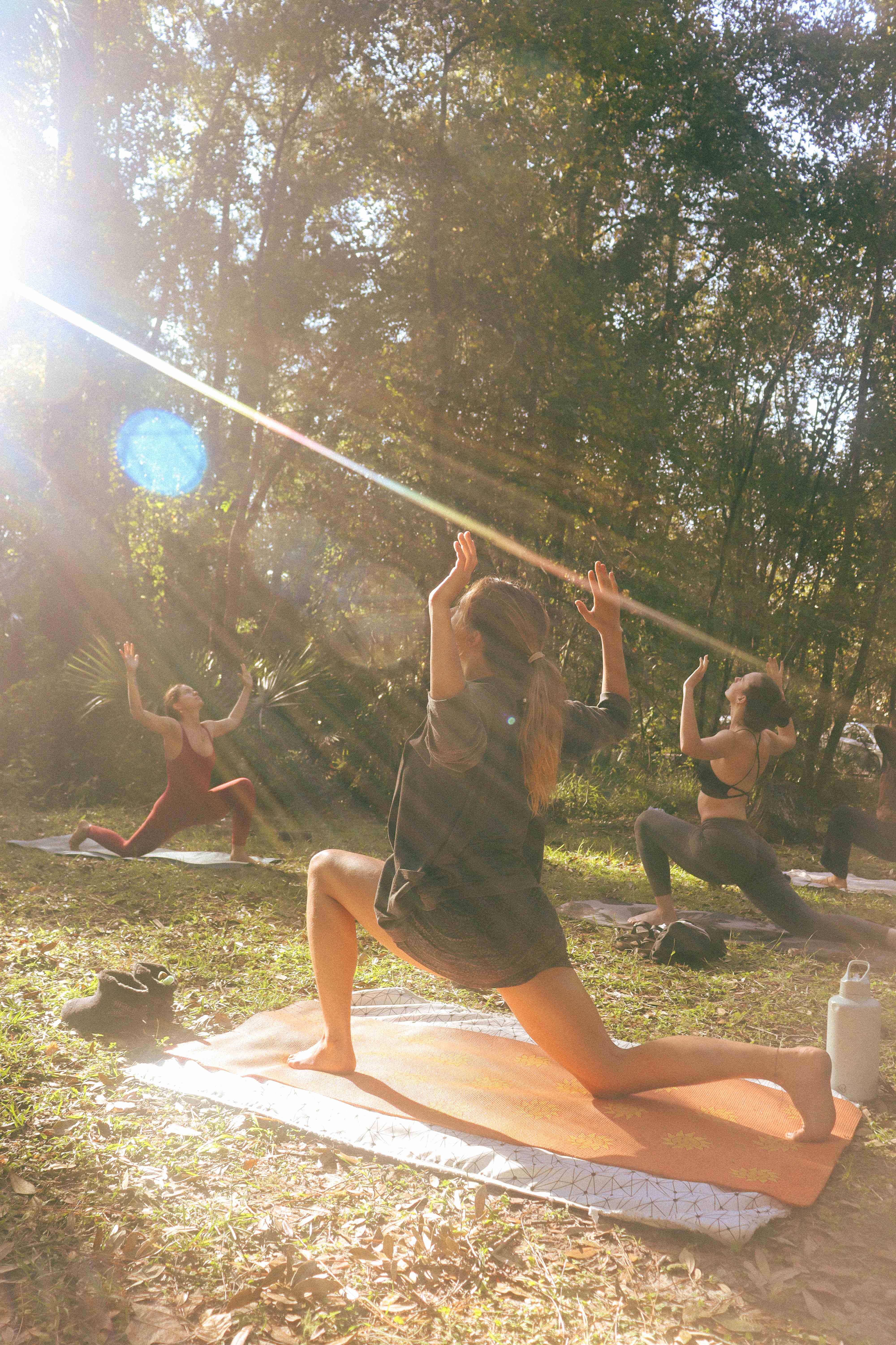 Group yoga practice with magical golden hour lighting