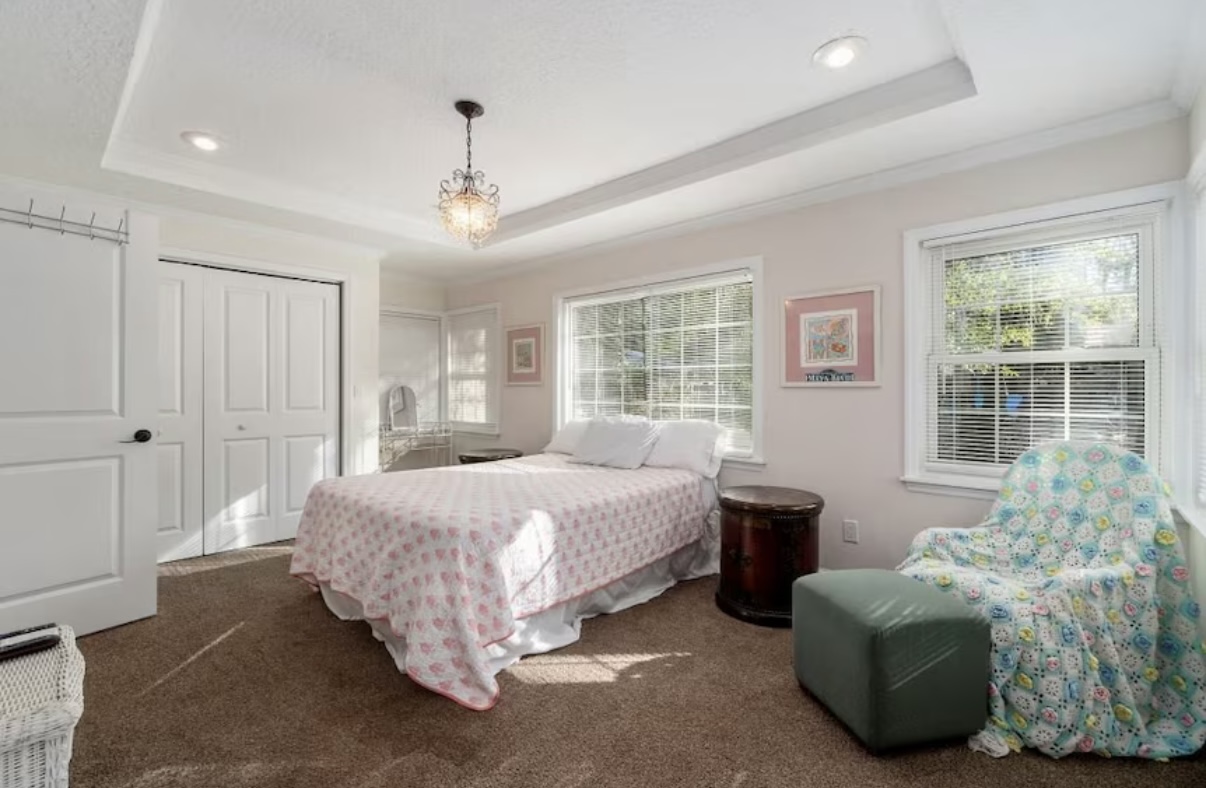Cozy bedroom with natural light and elegant chandelier