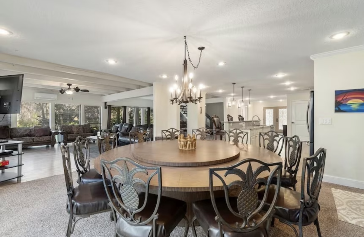 Elegant dining room with large round table and pineapple motif chairs