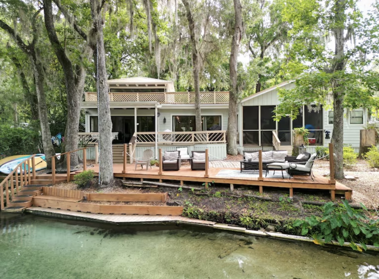 Dream River House exterior with wooden deck and spring water