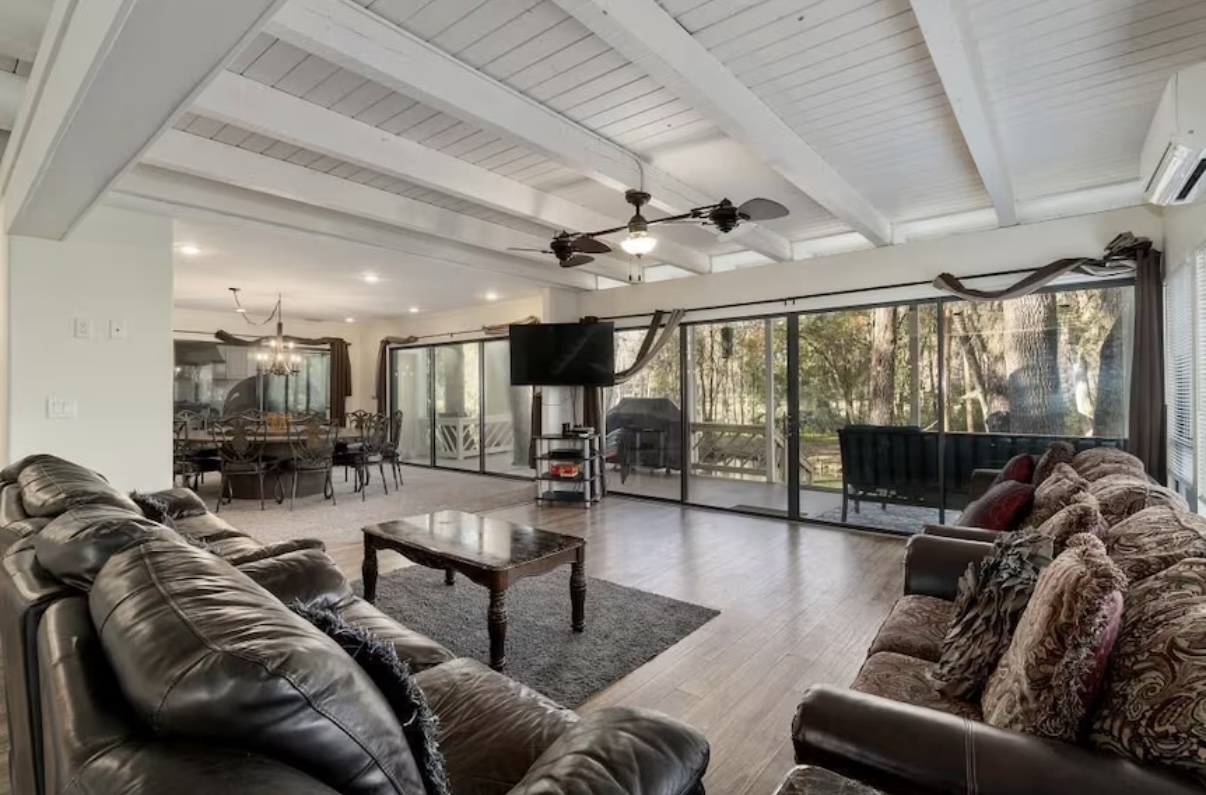Spacious living room with exposed beams and large windows