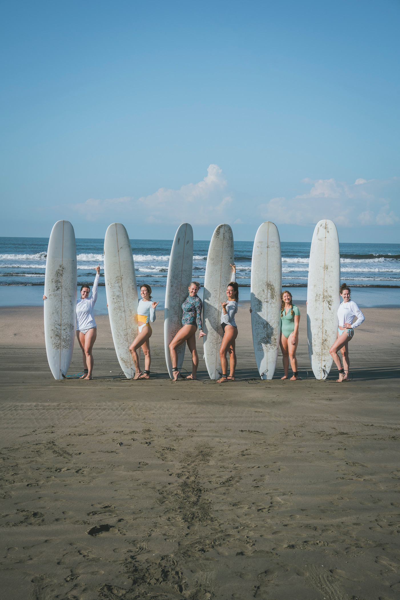 Group of women with surfboards on beach