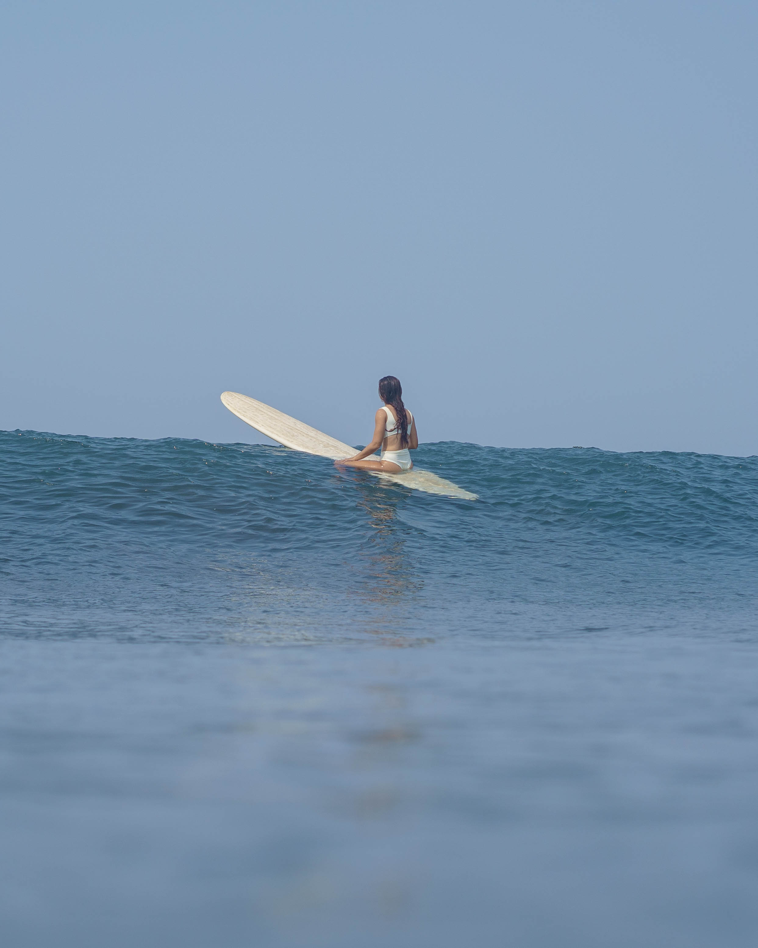 Woman surfing in calm ocean waters